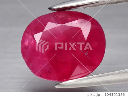 Natural gemstone red ruby on gray background 104501386