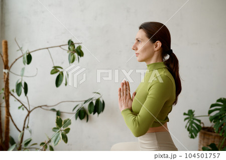 Side view portrait of young woman practicing yoga mindfulness technique Side view portrait of young woman practicing yoga mindfulness technique 104501757
