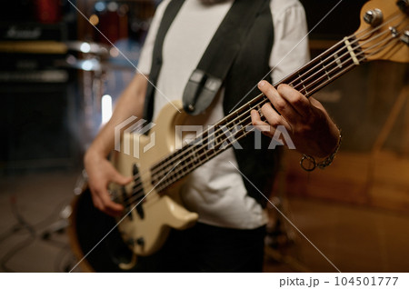Rock music band performance with cropped shot closeup view on hand of guitarist 104501777
