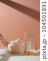 skincare and suncare with pestle and mortar and flower. horizontal with sunlight and shade. 104501891
