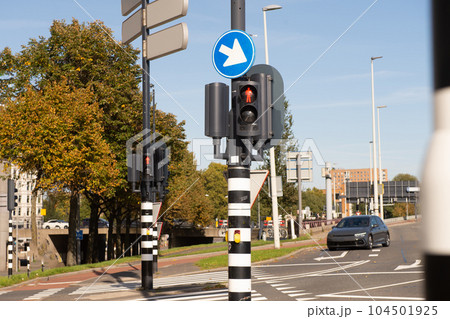 Traffic light-regulated intersection with road signs. Red traffic light 104501925