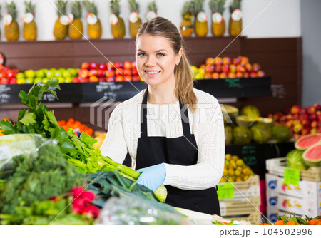 Salesgirl arranging greens Salesgirl arranging greens 104502996