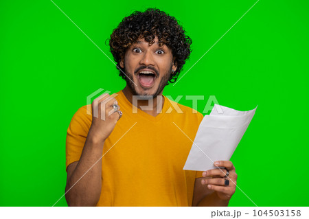 Indian man open envelope letter, great news celebrate, monetary award, invitation, bank loan approve Indian man open envelope letter, great news celebrate, monetary award, invitation, bank loan approve 104503158