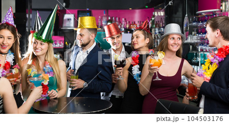 Portrait of happy women and men in caps with cocktails Portrait of happy women and men in caps with cocktails 104503176