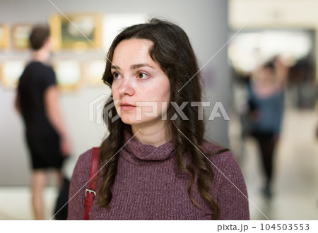 Woman visiting museum and thinking indoors 104503553