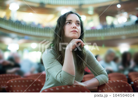 Adult woman theatre goer looking at play Adult woman theatre goer looking at play 104504014
