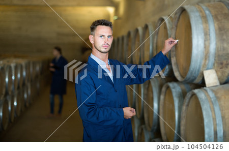 Man wearing uniform working and writing tag on woods Man wearing uniform working and writing tag on woods 104504126