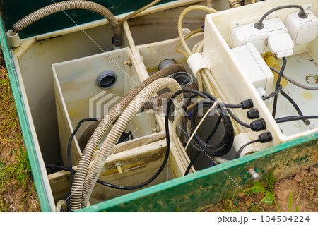 Private drainage systems. water sewer system. The green tin case is open for cleaning and maintenance on a sunny summer day 104504224