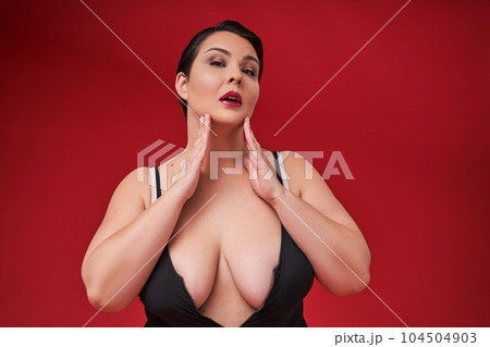 Fat sexy woman in underwear on red studio background 104504903