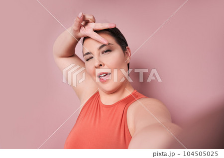 Attractive overweight female having delightful look smiling broadly 104505025