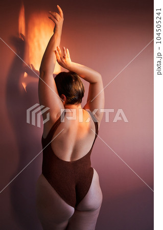 Rearview of young woman enjoying her natural body and curves 104505241