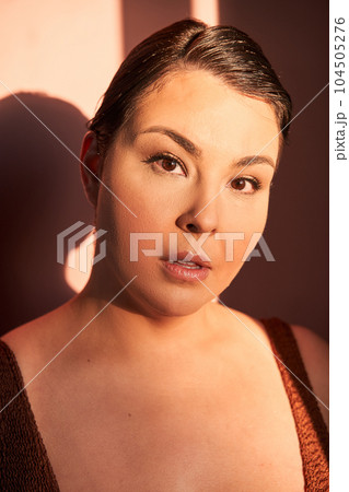 Portrait of plus size self enjoyed woman wearing lingerie posing isolated over pink background Portrait of plus size self enjoyed woman wearing lingerie posing isolated over pink background 104505276