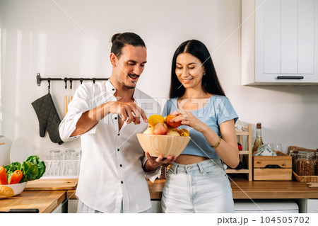 Healthy lovers cooking food in kitchen, Couple spending time together 104505702