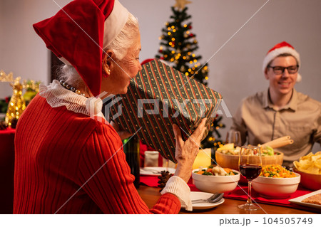 Happy family enjoying with Christmas celebration at home Happy family enjoying with Christmas celebration at home 104505749