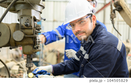 Smiling portrait of confident engineer worker at factory 104505829