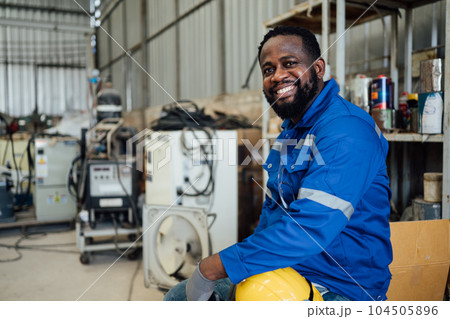 Smiling portrait of confident engineer worker at factory 104505896