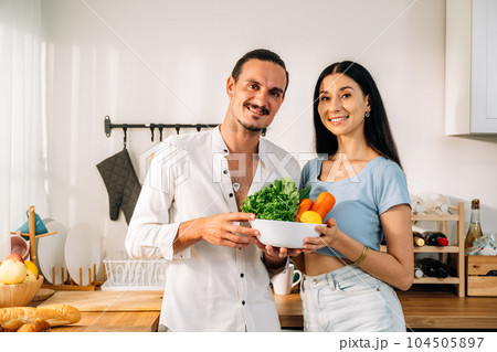 Healthy lovers cooking food in kitchen, Couple spending time together 104505897