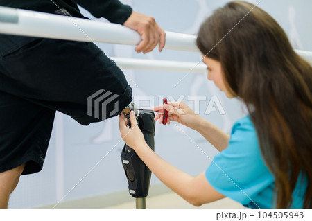 Female physiotherapist adjusting prosthetic leg of patient in hospital Female physiotherapist adjusting prosthetic leg of patient in hospital 104505943