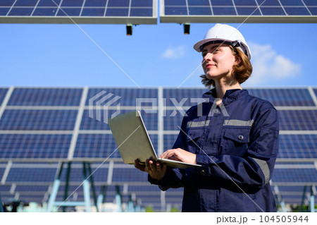 Engineer worker portrait with solar panel at solar farm Engineer worker portrait with solar panel at solar farm 104505944