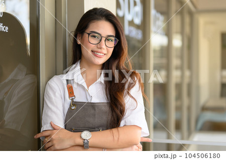 Smiling portrait of young barista business owner at retail coffee shop Smiling portrait of young barista business owner at retail coffee shop 104506180