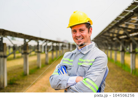 Maintenance engineer checking solar panels on solar cell farm Maintenance engineer checking solar panels on solar cell farm 104506256