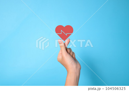 People holding heartbeat icon on hands with pink background 104506325