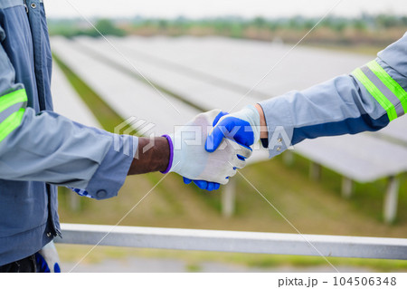 Happy maintenance engineer checking and maintaining solar panels 104506348