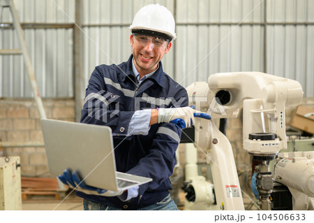 Engineer technician controlling robotic arms on computer laptop Engineer technician controlling robotic arms on computer laptop 104506633