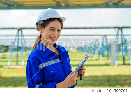 Workers installing solar panels, Engineer team at solar panel farm 104506701
