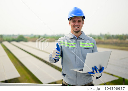 Maintenance technician working on ecological solar cell farm 104506937