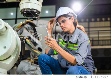 Female engineer worker working with robotic machine automation Female engineer worker working with robotic machine automation 104506997