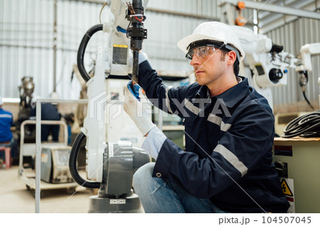 Engineer technician controlling robotic arms on computer laptop 104507045