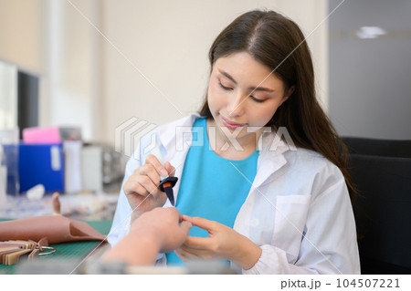 Technician making prosthetic device using grinder to smooth socket Technician making prosthetic device using grinder to smooth socket 104507221