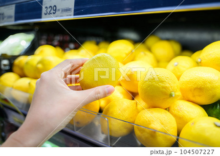 Young adult woman using phone in grocery store Young adult woman using phone in grocery store 104507227