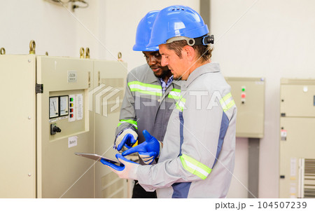 Happy maintenance engineer checking and maintaining solar panels Happy maintenance engineer checking and maintaining solar panels 104507239