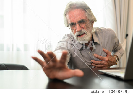Senior man holding hand on chest and suffering from heart problem Senior man holding hand on chest and suffering from heart problem 104507399