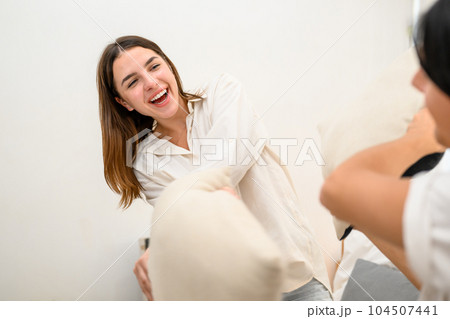 Couple of happy young people spending time together at home on weekend Couple of happy young people spending time together at home on weekend 104507441