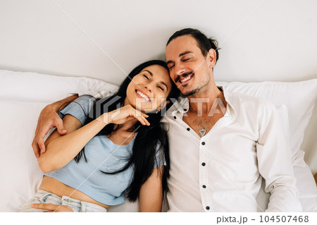 Happy young couple of husband and wife spending time together at home Happy young couple of husband and wife spending time together at home 104507468