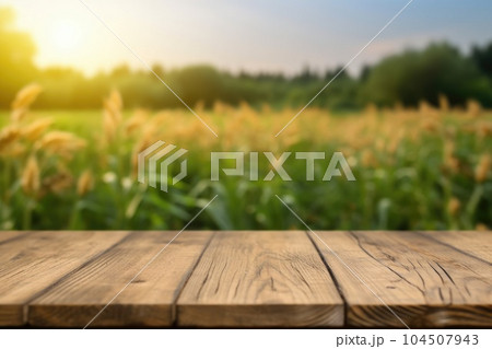 The empty wooden brown table top with blur background of corn field. Exuberant. The empty wooden brown table top with blur background of corn field. Exuberant. 104507943