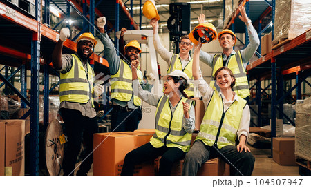 Professional warehouse worker team celebrating success in warehouse factory 104507947
