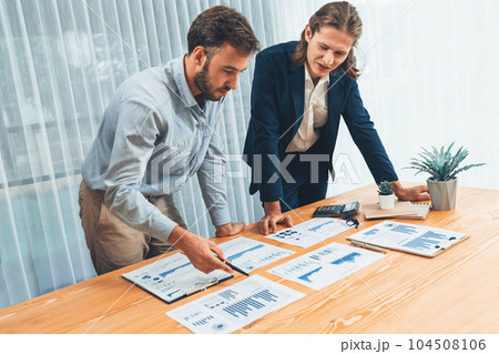 Analyst team in office analyzing financial data analysis papers. Entity Analyst team in office analyzing financial data analysis papers. Entity 104508106