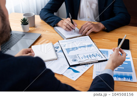 Busy analyst team in office analyzing financial data analysis. Entity Busy analyst team in office analyzing financial data analysis. Entity 104508156