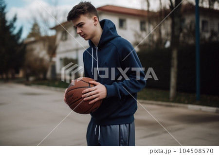 Male Caucasian teenager playing basketball driveway activity. Generative AI AIG23. 104508570