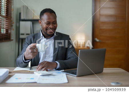 middle aged man American African using computer laptop with planning working on financial document, tax, exchange, accounting and Financial advisor. middle aged man American African using computer laptop with planning working on financial document, tax, exchange, accounting and Financial advisor. 104509939