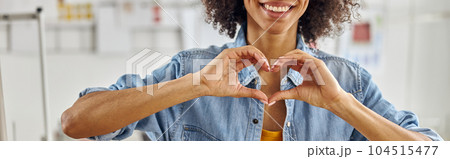 Smiling African-American fashion designer in denim shirt shows h Smiling African-American fashion designer in denim shirt shows h 104515477