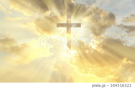 Christian cross appears bright in the gold sky 104516322