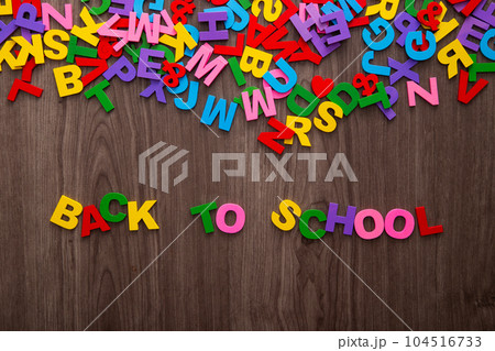 Back to school sign formed from colorful plastic letter on wooden background Back to school sign formed from colorful plastic letter on wooden background 104516733