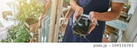 Male seller with bank terminal at shop doorlet Male seller with bank terminal at shop doorlet 104516763
