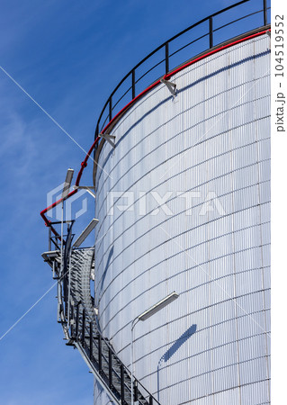 Oil storage tanks with blue sky background, Industrial tanks for petrol and oil, White fuel storage tank against blue sky. Oil storage tanks with blue sky background, Industrial tanks for petrol and oil, White fuel storage tank against blue sky. 104519552