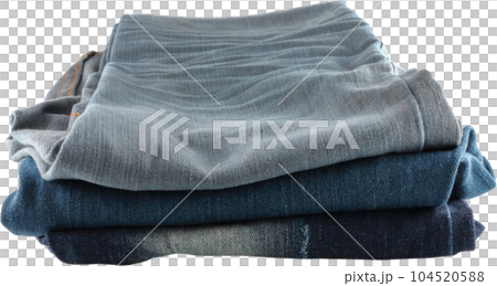 Many jeans stacked. 104520588